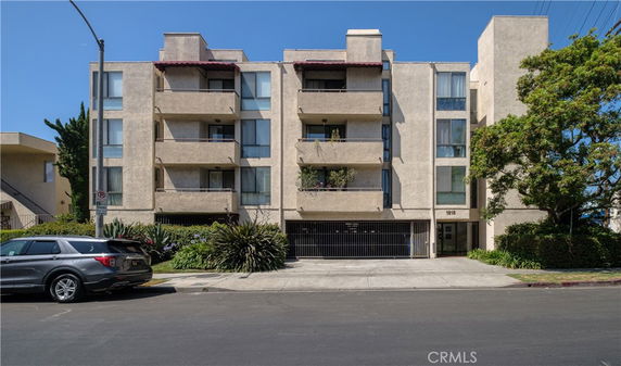 Front view of a multi-story apartment building with balconies.