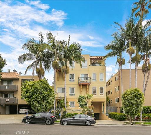 Front view of a multi-story apartment building with balconies.
