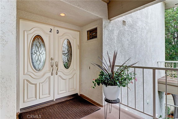 Front view of an entrance with double doors featuring decorative glass inserts.