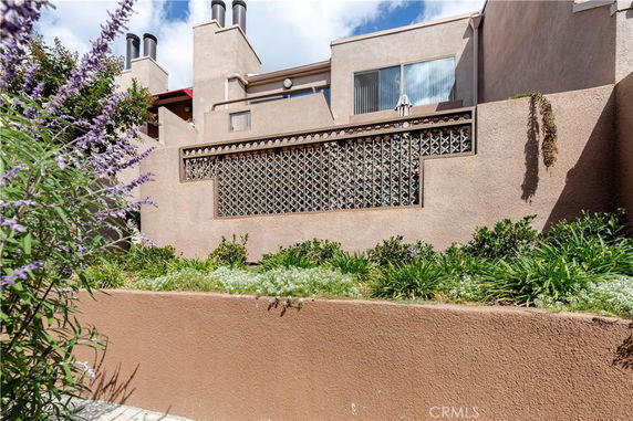 Front view of a multi-story building with decorative wall elements.