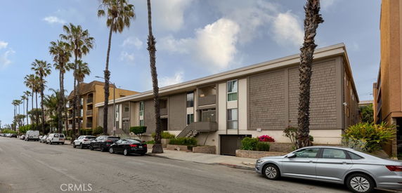 Front view of a multi-story apartment building with a modern design.