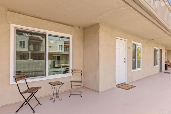 View from a balcony showing the exterior of nearby apartment buildings.