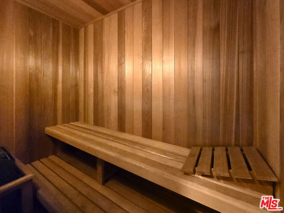 Interior view of a wooden sauna room with benches.