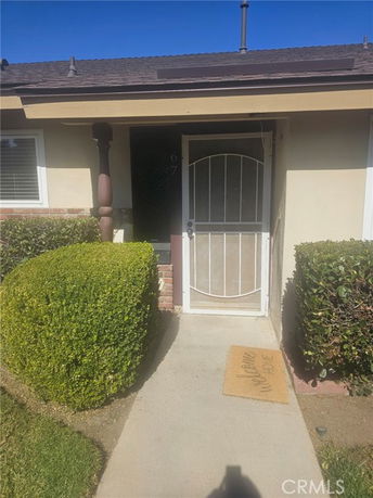 Front view of a single-story house with a pathway leading to the entrance.