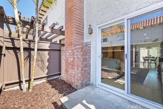 Exterior view of a house with sliding glass doors and a brick chimney.