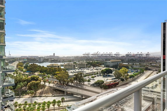 Panoramic view of a cityscape with bridges, roads, and shipping port seen from a building.