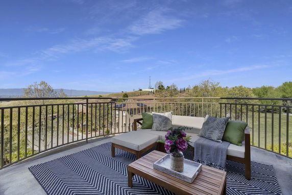 Outdoor patio area with a seating arrangement, offering a view of the surrounding landscape.
