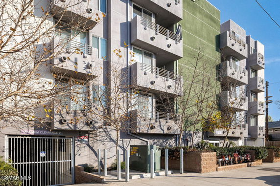 Front view of a multi-story apartment building with balconies.
