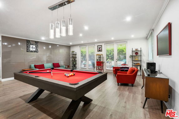 Indoor recreation room with billiards table and seating area.