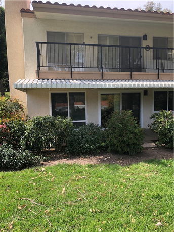 Front view of a two-story house with a balcony.