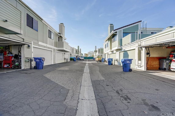 Outdoor parking area in front of multi-story residential buildings.