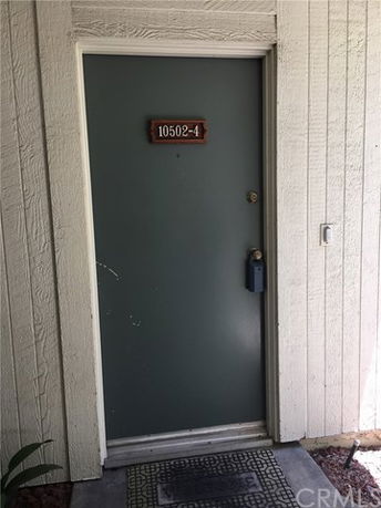 Front view of a building entrance door with a unit number.