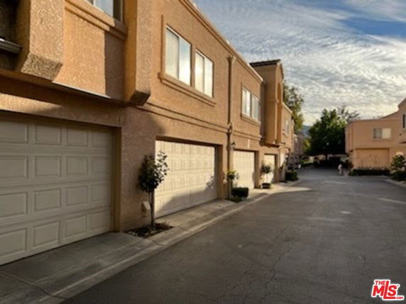 Street view of residential buildings with multiple garages.