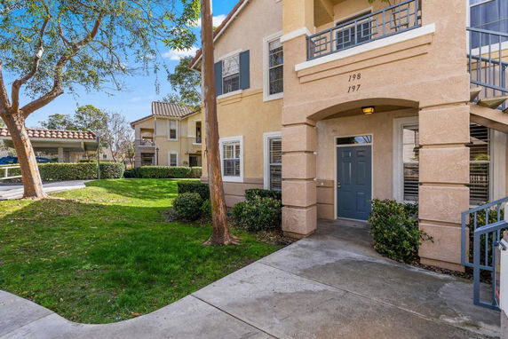 Front view of a multi-unit residential building with outdoor entrance.