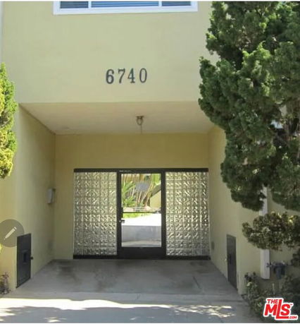 Entrance view of a building with a door and glass block walls.