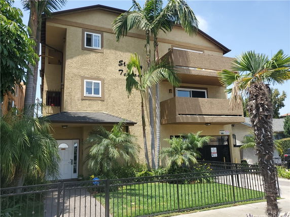 Front view of a multi-story residential building with balconies.