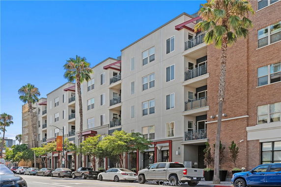 Front view of a multi-story apartment building with balconies.