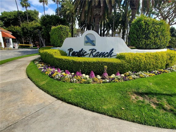 Entrance sign for a property named Pacific Ranch surrounded by landscaping and palm trees.