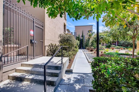 Exterior pathway with gated entrance and landscaped surroundings.