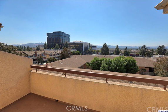 Panoramic view from a rooftop showing surrounding buildings and landscape.