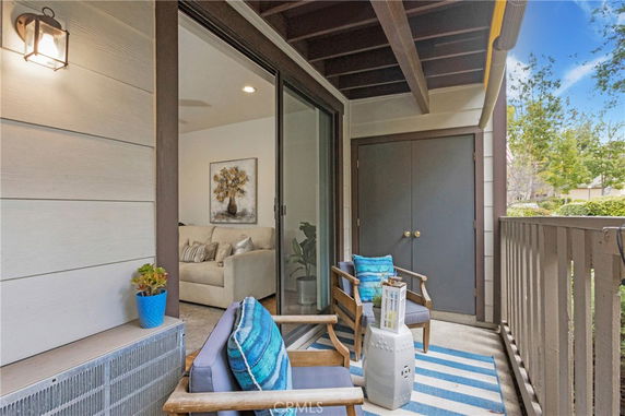 Outdoor patio area with chairs and a view of surrounding trees