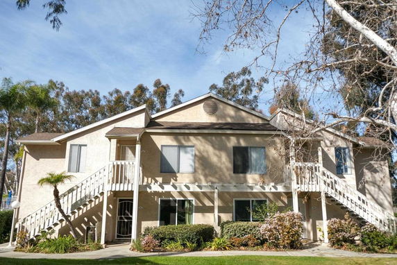 Front view of a two-story house with external staircases