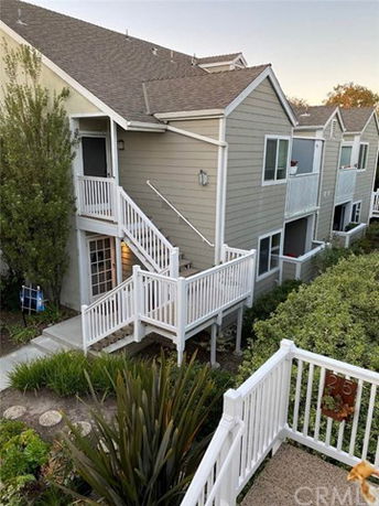 Elevated view of a multi-story residential building with exterior stairs and balconies.