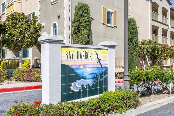 Front view of a building with a sign reading 'Bay Harbor' in front.