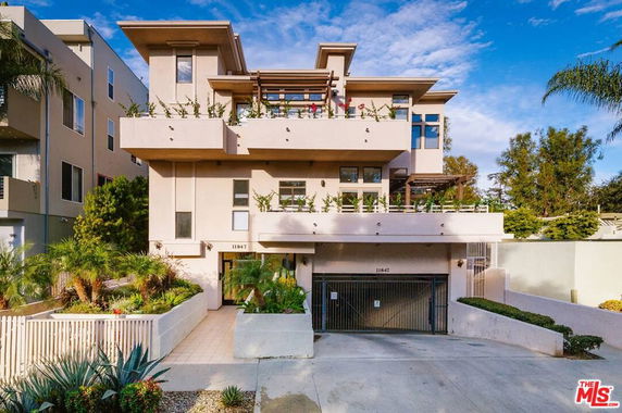Front view of a multi-story modern building with balconies.