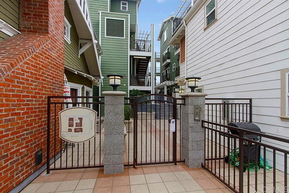Front view of a multi-story building with a gated entrance.