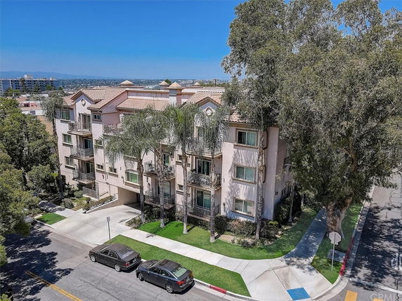 Front view of a multi-story apartment building with balconies.