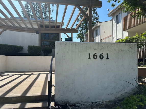 Front view of a building with address number 1661 displayed on a wall.