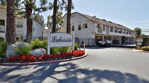 Front view of an apartment building with a gated entrance.