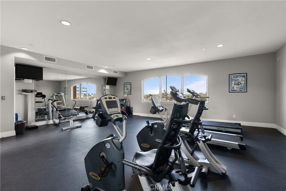 Indoor gym area with exercise bikes and treadmills.