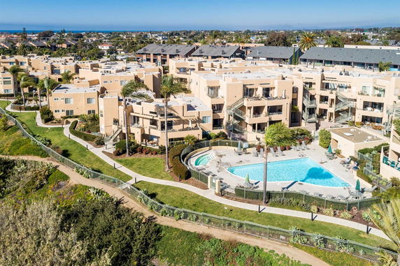 Aerial view of an apartment complex with a central swimming pool.