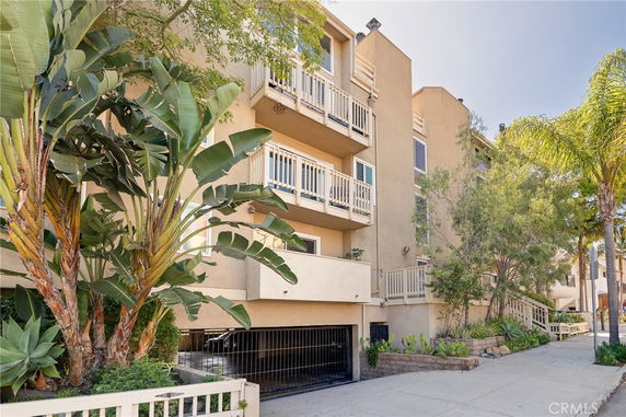 Front view of a multi-story residential building with balconies.