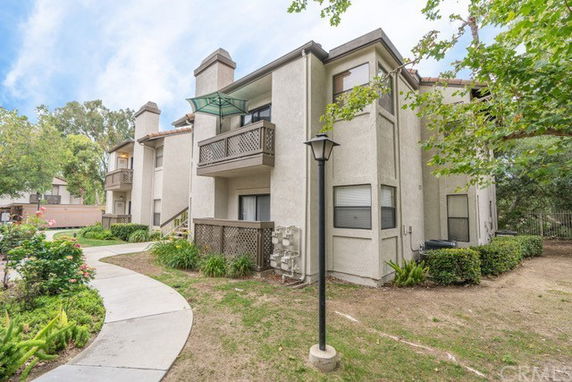 Front view of a multi-story building with balconies.