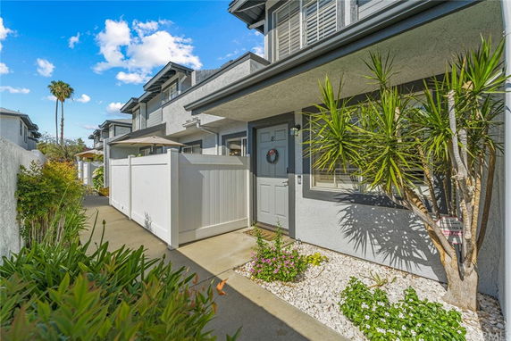 Front view of a townhouse with a fenced entrance.