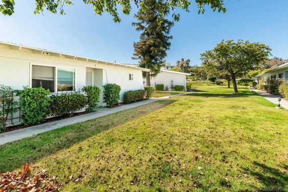 Side view of single-story houses with landscaped garden areas.