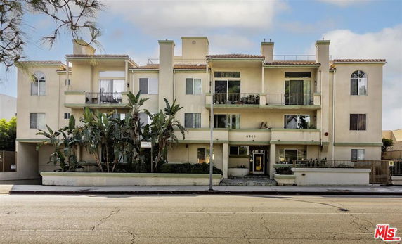 Front view of a multi-story residential building with balconies.