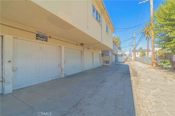 Outdoor parking area beneath a residential building.