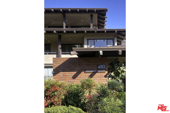 Front view of a multi-story building with a brick facade.