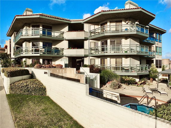 Front view of a multi-story building with balconies and a modern design.