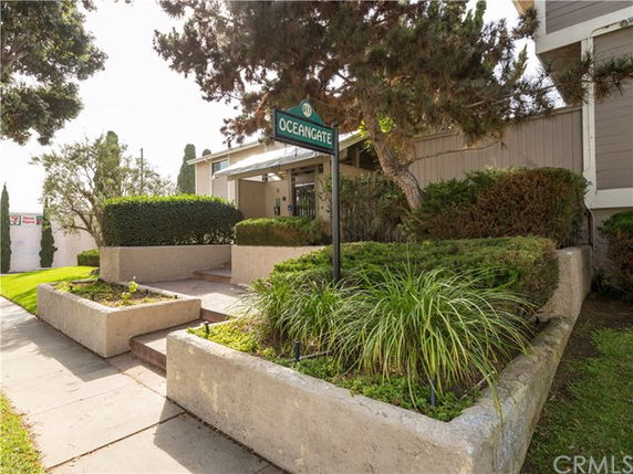 Front view of a building entrance with stairs and landscaping.