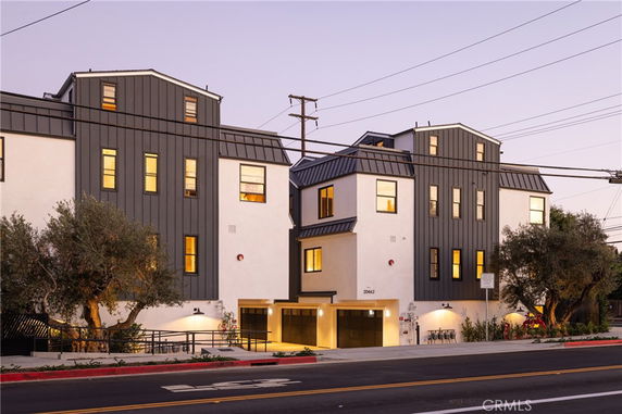 Front view of a multi-story residential building with modern architectural design.