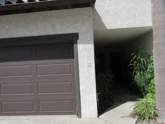 Front view showing a garage door and entrance area of a house.