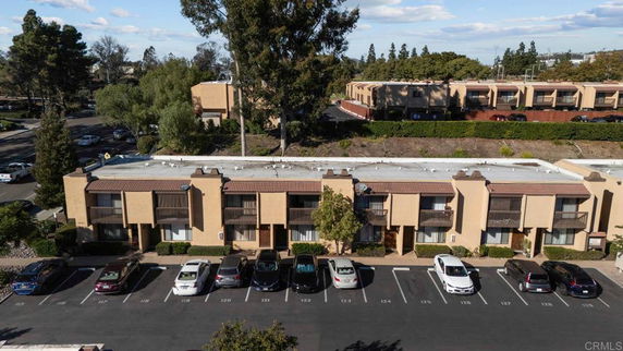Front view of an apartment complex with parked cars.