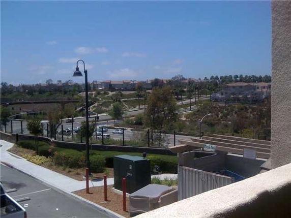 View from a building overlooking roads and greenery.