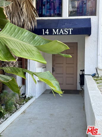 Front view of a building entrance with an awning displaying '14 MAST'.
