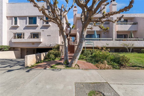 Front view of a multi-story residential building with balconies.